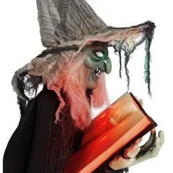 Sorcière debout tenant un livre lumineuse et sonore