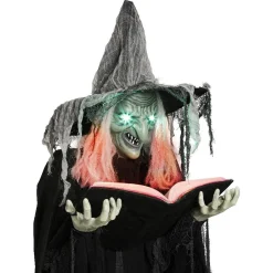 Sorcière debout tenant un livre lumineuse et sonore